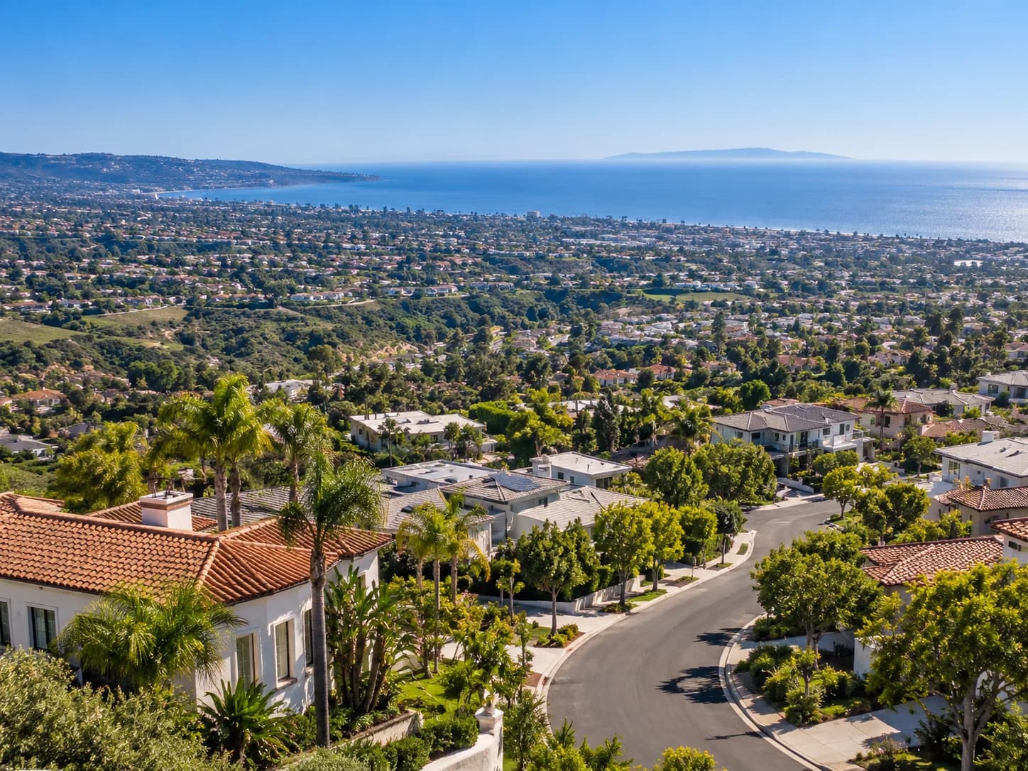 A hillside residential neighborhood overlooking the coastline and ocean