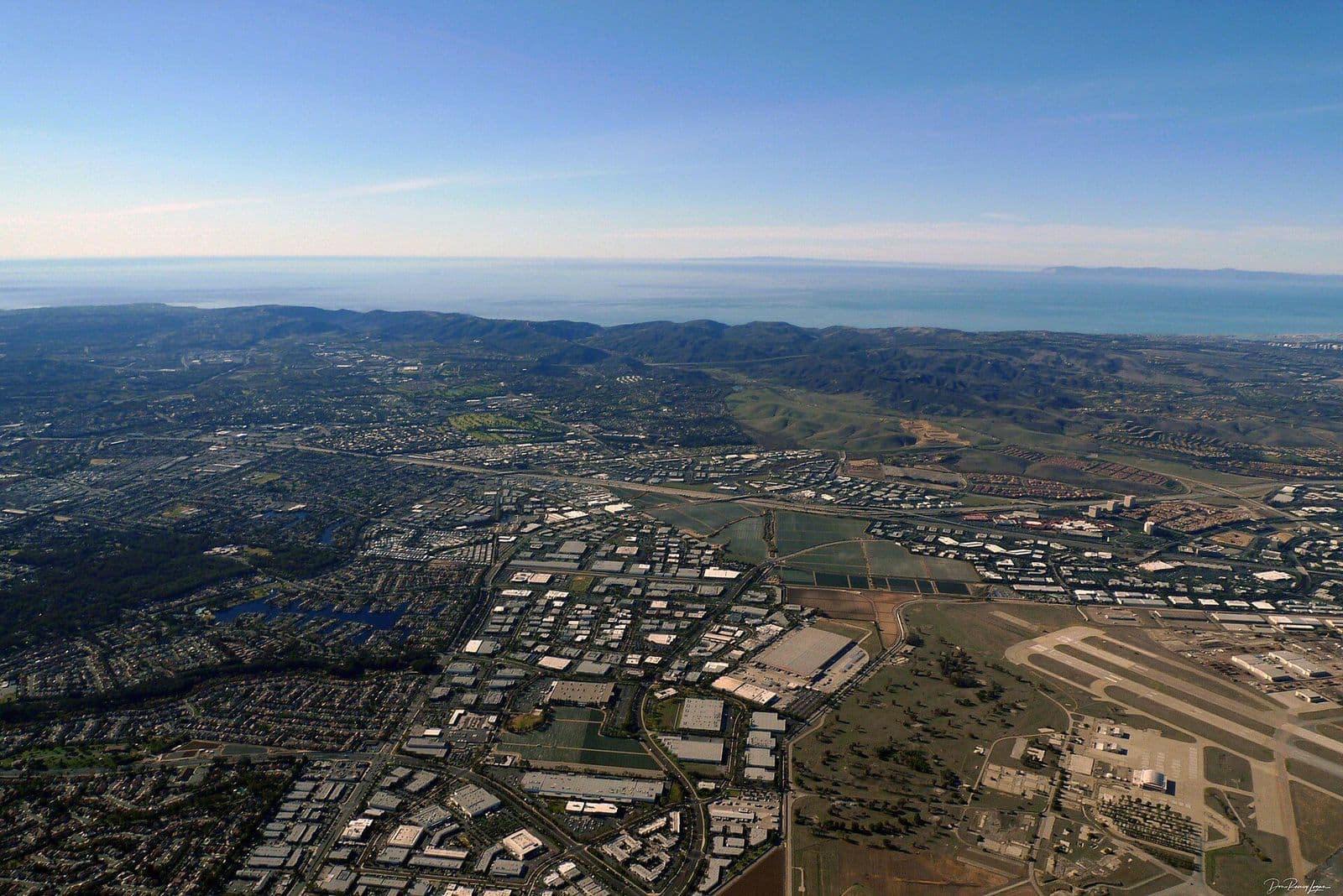Aerial view over Lake Forest and Laguna Hills toward the ocean